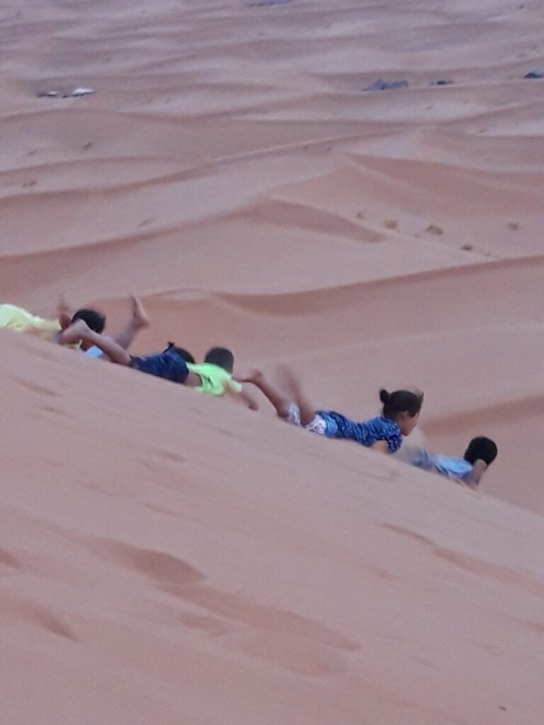 children playing in the dunes